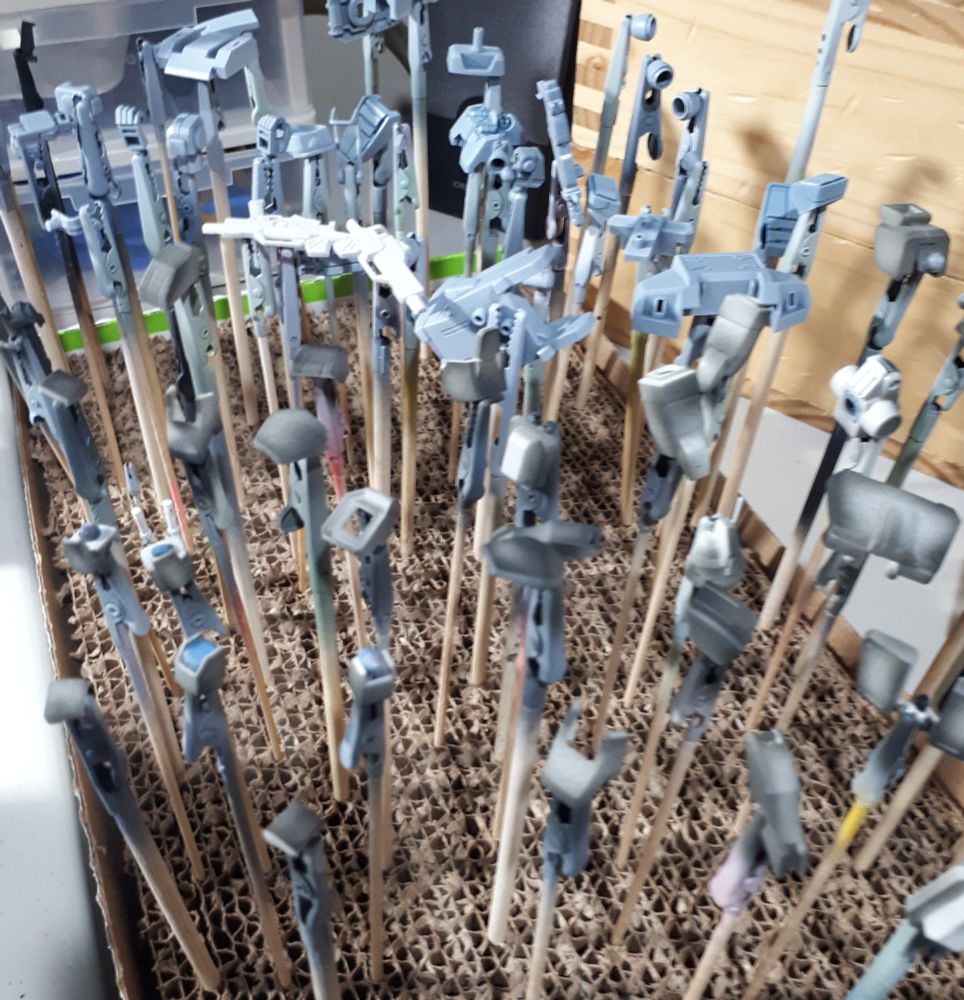 HG EZ8 parts all on clip sticks, primed and some pre-shaded waiting for some gunpla hack to paint them and stop being so lazy. Geez, he couldn't even focus the photo right, useless!