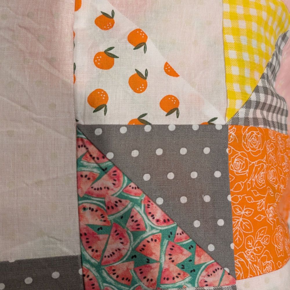 some triangle squares with oranges, watermelon, gingham, and orange flowers