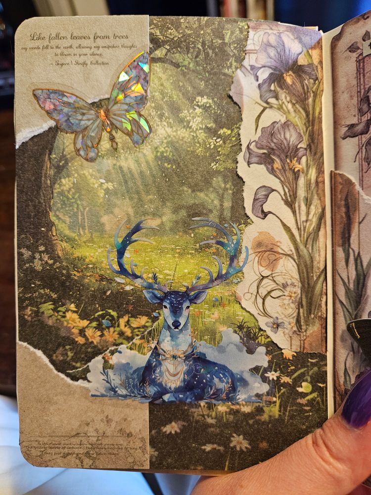 A scrapbook page with a forest background. Sun beams filter through the left side where an iridescent butterfly sits in the top left corner. A torn sheet with purple iris flowers is on the right. In the middle sits a cosmic blue deer. 

The artist feels this page didn't turn out they way they wanted.