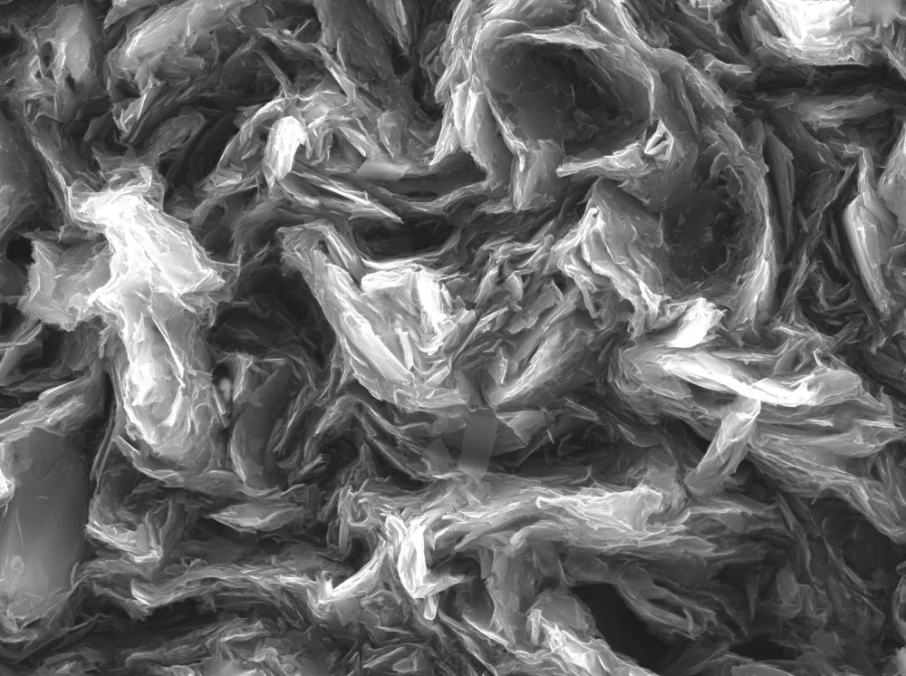 Scanning electron microscope image of a pencil lead at 20,000X.  Graphite flakes can be seen in a swirly fashion 