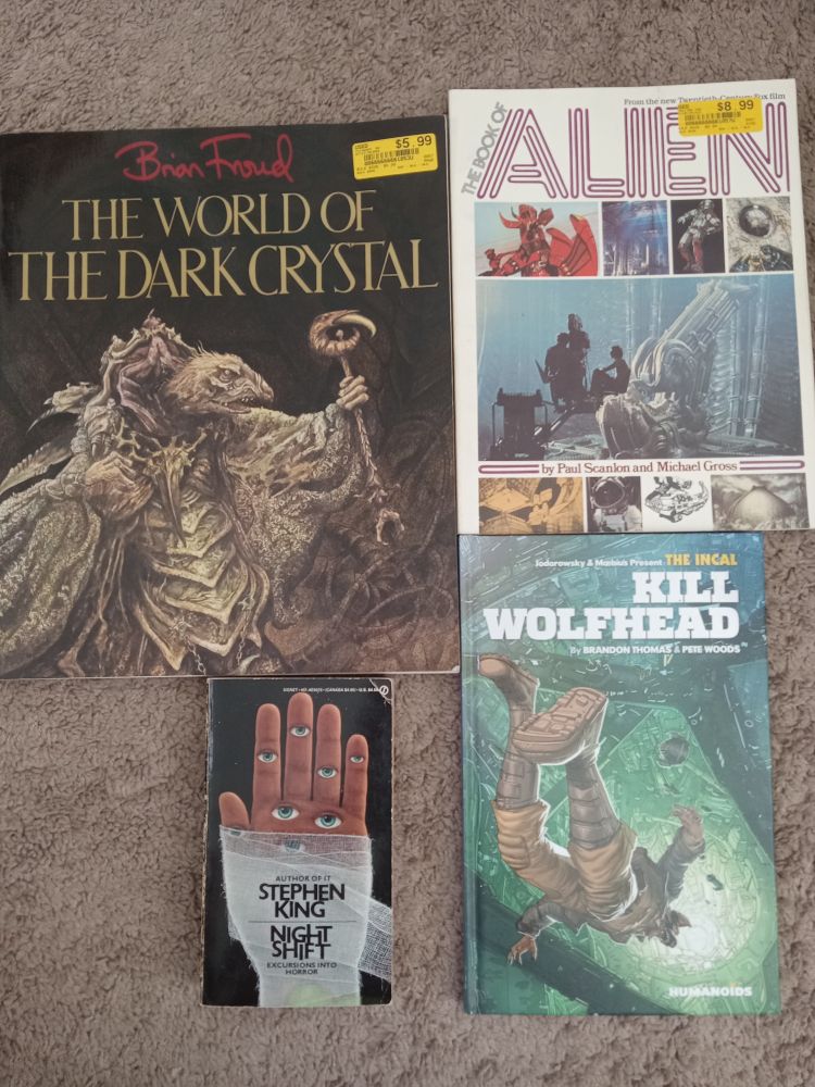 Four books; The World of the Dark Crystal art book, The Book of Alien (art and production book of the movie 1979), Kill Wolfhead graphic novel from the Incal universe, and the 1979 edition of Stephen King's Night Shift with the bandaged hand with eyeballs cover.