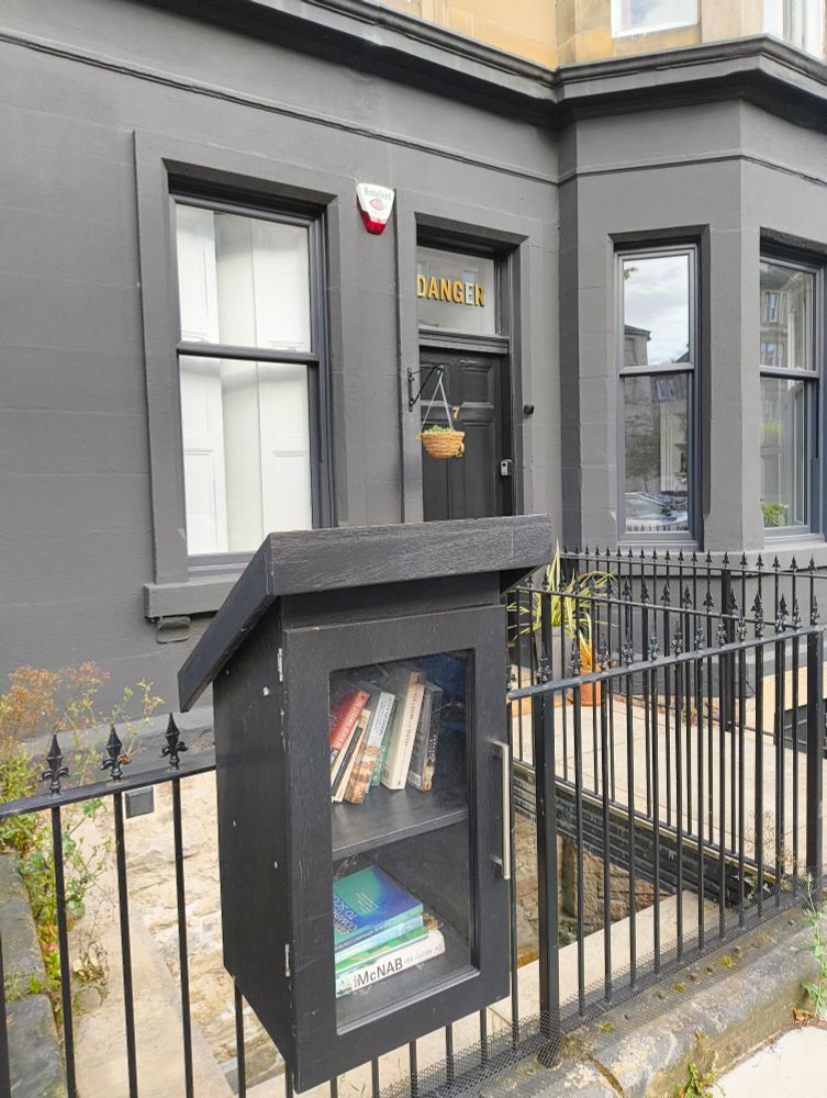 Grey house in Edinburgh with matching little free library box