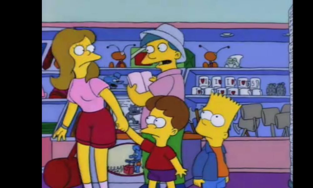 A scene from the Simpson’s episode. A mother is holding her son Bort’s hand, while a man named Bort asks if she is talking to him. She informs him that her son is also named Bort. Bart Simpson stands to the side. 