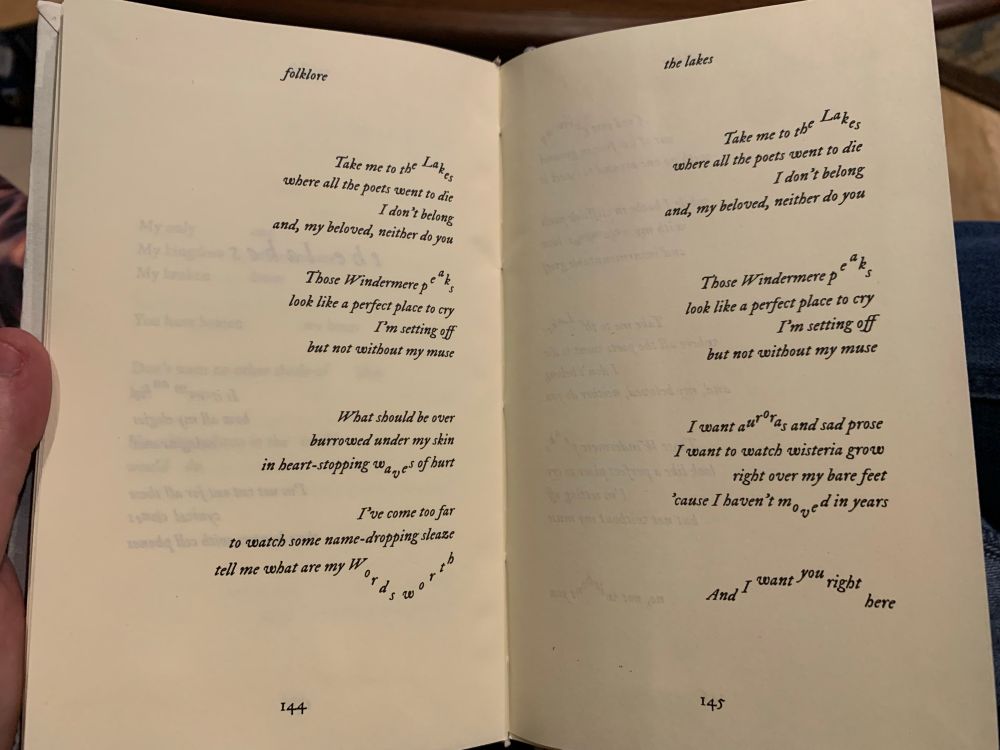 A photo of a handmade book, open to a page displaying the lyrics to the lakes by Taylor Swift