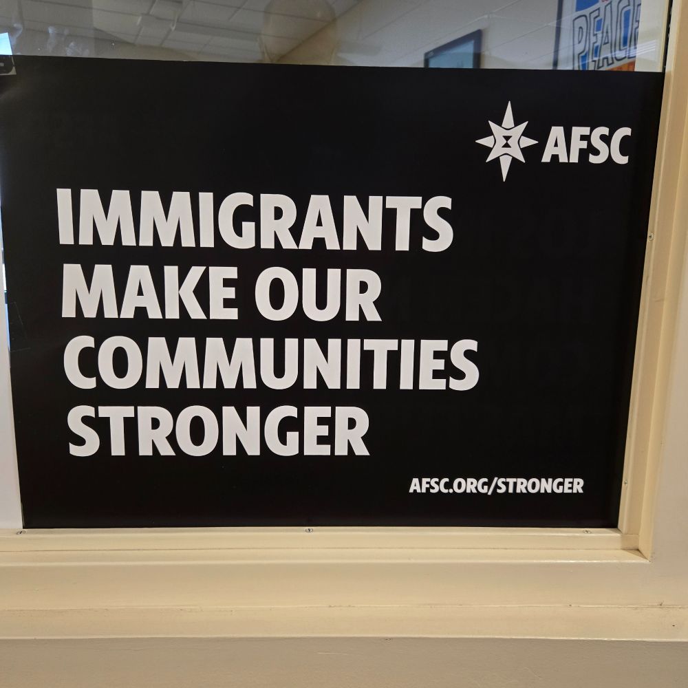 Sign says, AFSC. Immigrants make our communities stronger. afsc.org/stronger