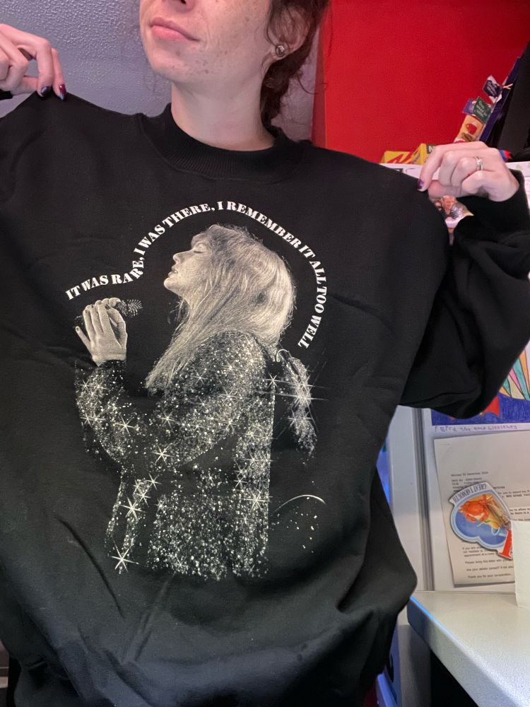 Taylor Swift merch black jumper. Picture of Taylor performing All Too Well with the lyrics “it was rare, I was there. I remember it all too well”