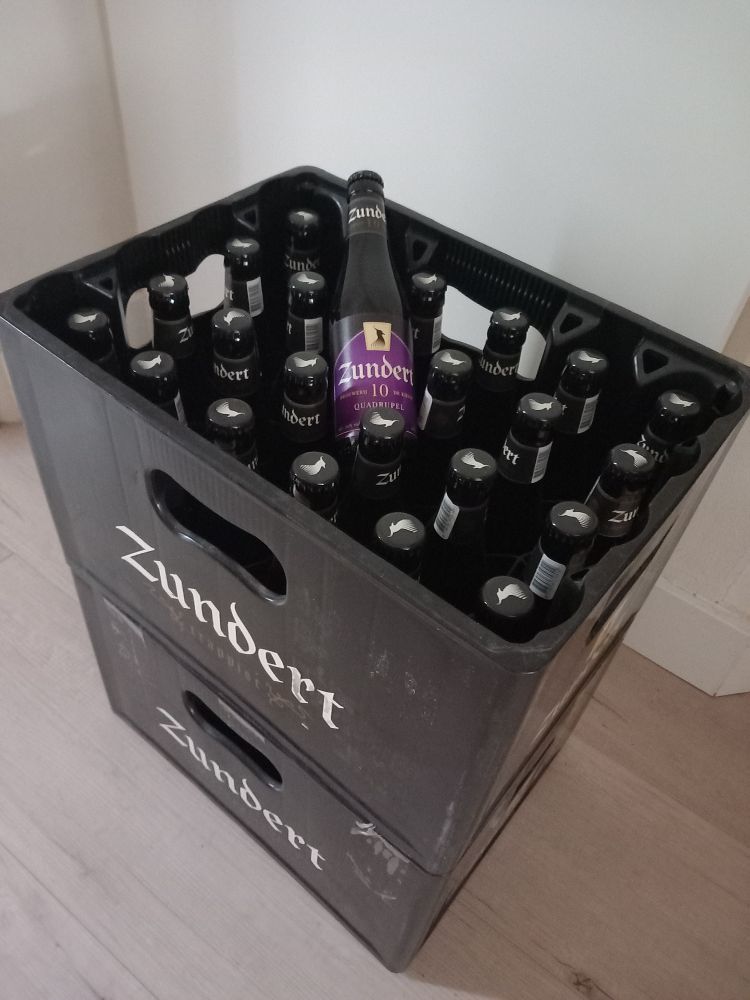 Foto van twee gestapelde bierkratten met het opschrift: Zundert trappist.
In de kratten flesjes met etiket. Zie andere afbeelding.