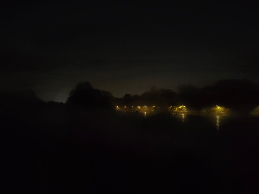 Freezing fog over the Thames river at night
