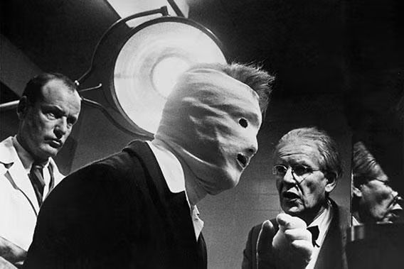 A haunting image of a bandaged face that manages to look ghostly while also making me think of those old stained glass images of the saints with their halos. The surgical lamp poking out from behind this monster's head giving the same effect - very cool