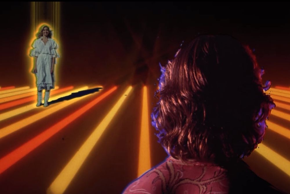 Beck looks longingly at Olivia across time and space, as depicted by blowing orange lines out of your wildest coke-fuled disco dreams 