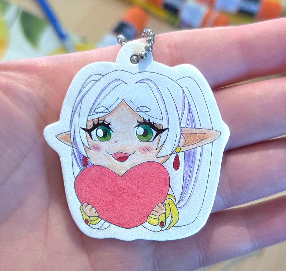 A handmade shrinky dink keychain of Frieren.
