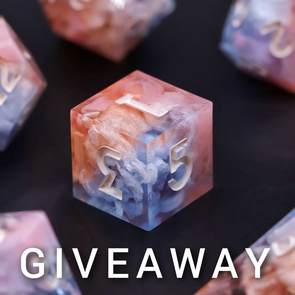 A picture of a D6 in focus. It is orange pink and blue with little clouds and white numbers.
Below are the letters G I V E A W A Y.