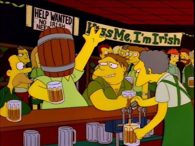 Homer Simpson at Moe’s on St. Patrick’s day, wearing a beer barrel over his head.