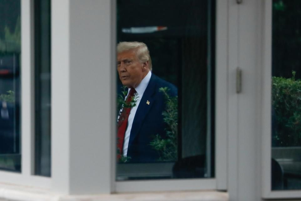 Trump, glimpsed through the White House window.