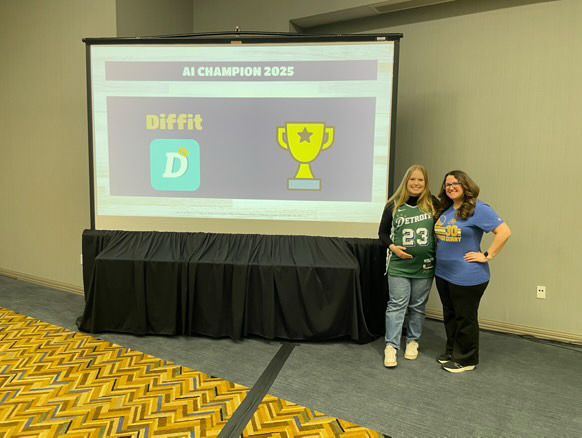 2 presenters posing with the presentation winner slide of Elite 8 EdTech at the MACUL conference. AI tool winner was Diffit. 