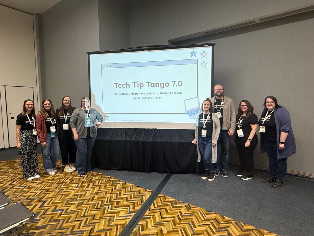 8 presenters posing with the title slide of Tech Tip Tango 7.0 at the MACUL conference