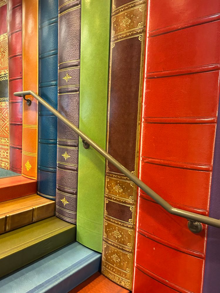 The staircase into the children’s section of the KC public library. Behind the handrail is painted to look like book bindings, similar to the wall outside the library. 