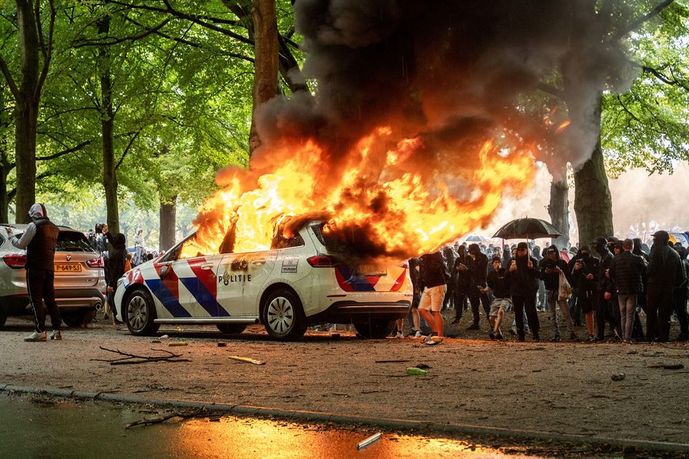 far-right demonstration in the Hague escalated by soccer hooligans resulted in violent clashes with police, several cars were torched.