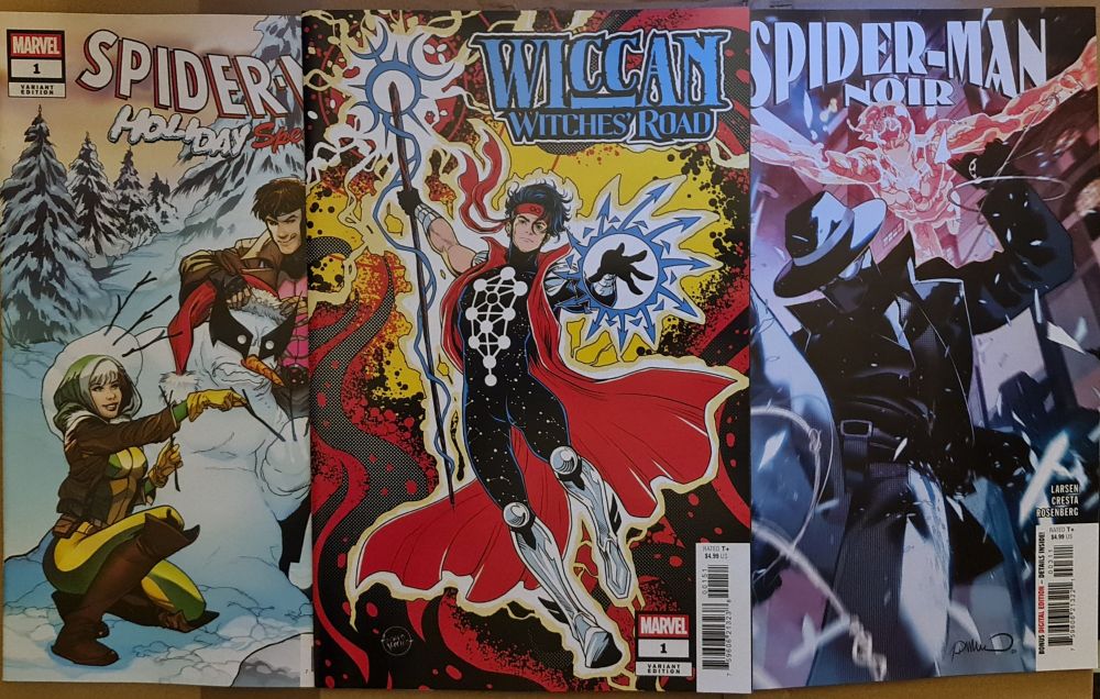 Image shows 3 comic books, Spider Man holiday special, wiccan witches road and Spiderman noir