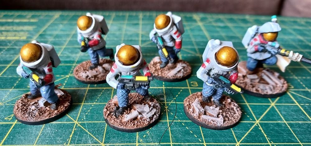 Squad of miniatures in space-suits with guns