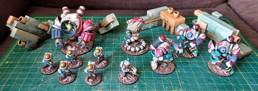 Family shot of moon/space themed miniatures in front of green walls