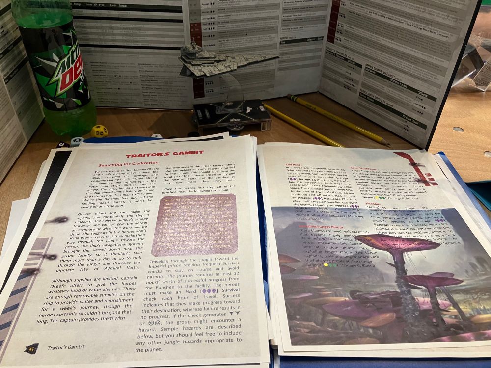 A picture of a GM screen with a bottle of Mtn Dew, story module, and model of a Star Wars Star-destroyer with dice.