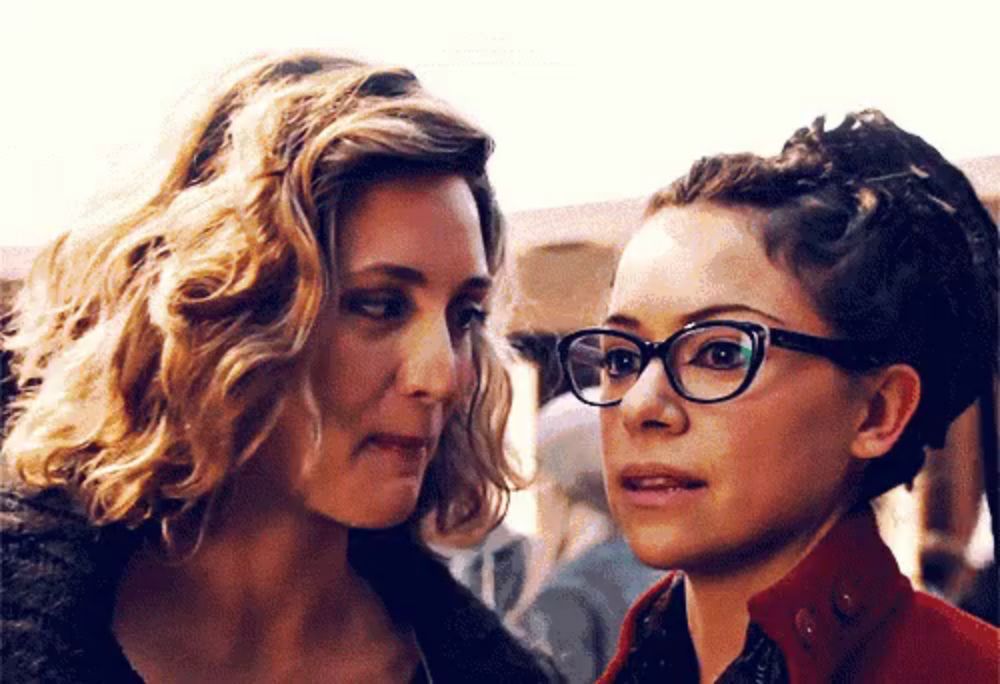 two women are looking at each other and one has glasses