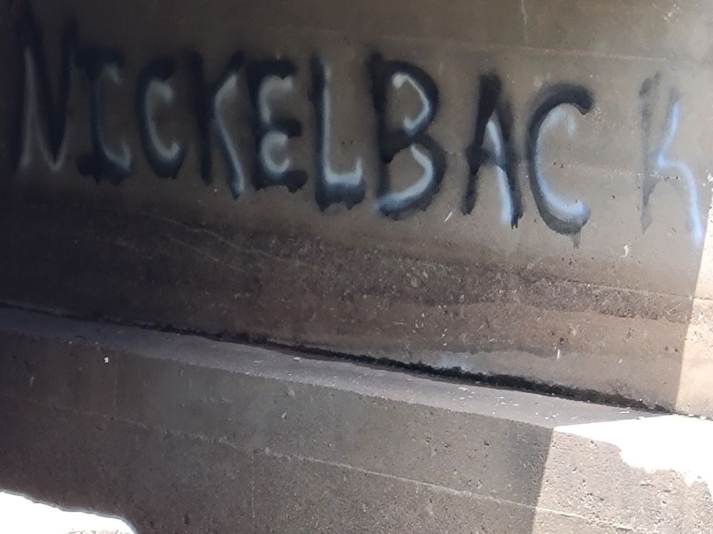 Nickelback spray painted under a bridge
