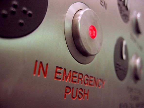 Red button on instrument panel with label: "IN EMERGENCY PUSH"