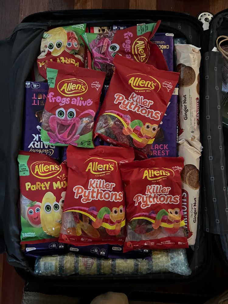 The top level has multiple bags of Allen’s Killer Pythons, Frogs Alive, Party Mix, and chocolate.