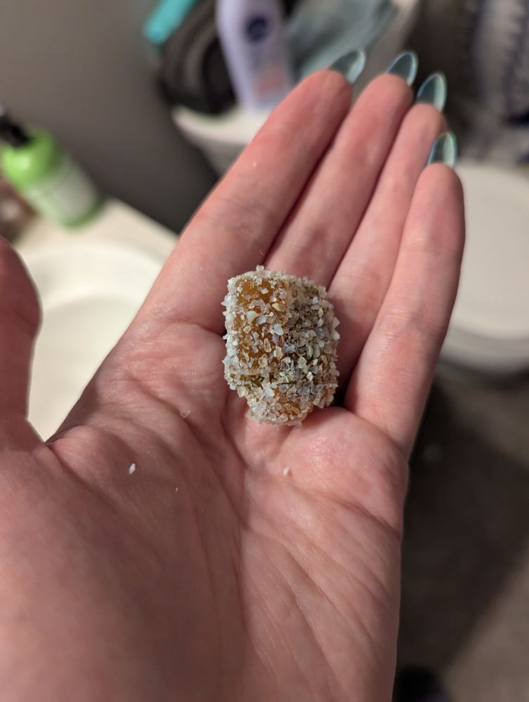 A clump of four gummies covered in silica cat litter. Mmmmmmm crunchy 