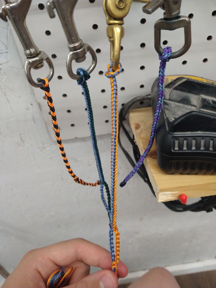 8 strand braided glove clips for Raptor Handling with the colors black and orange, blue and green, blue and orange, and blue and purple. 