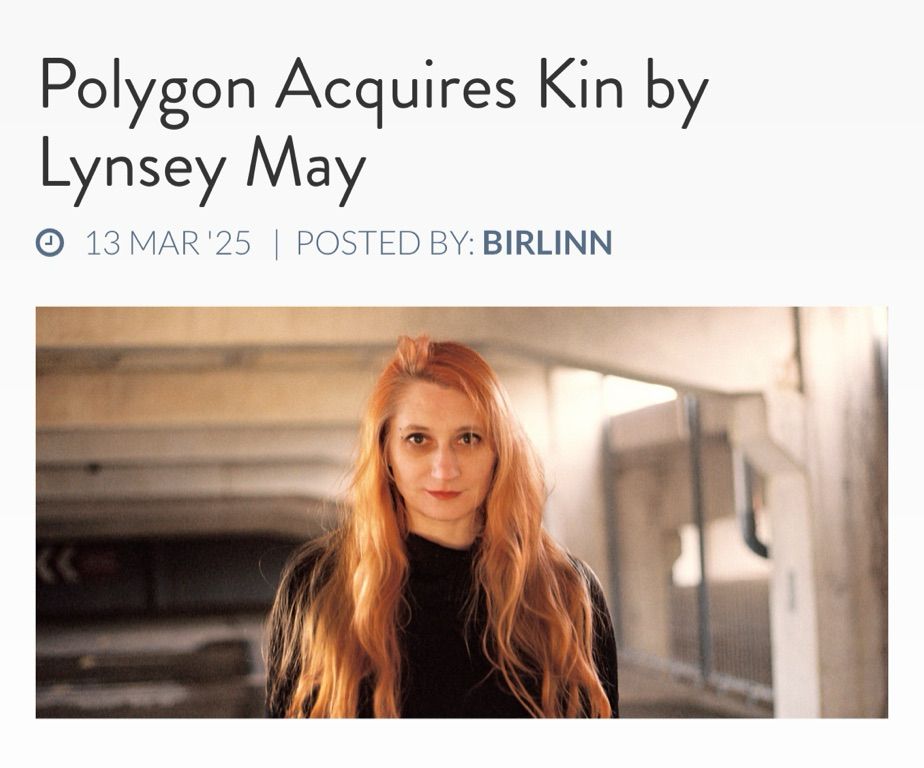 Woman with long ginger hair and a black top facing the camera with the title Polygon Aquires Kin by Lynsey May above it