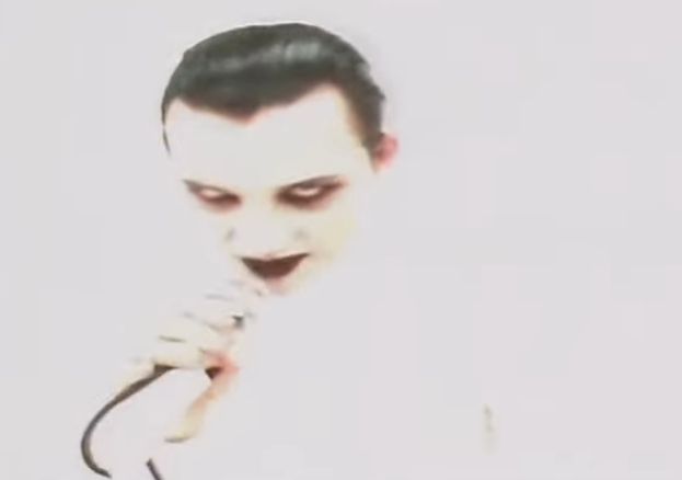 Dave Vanian of The Damned is wearing a white turtleneck.