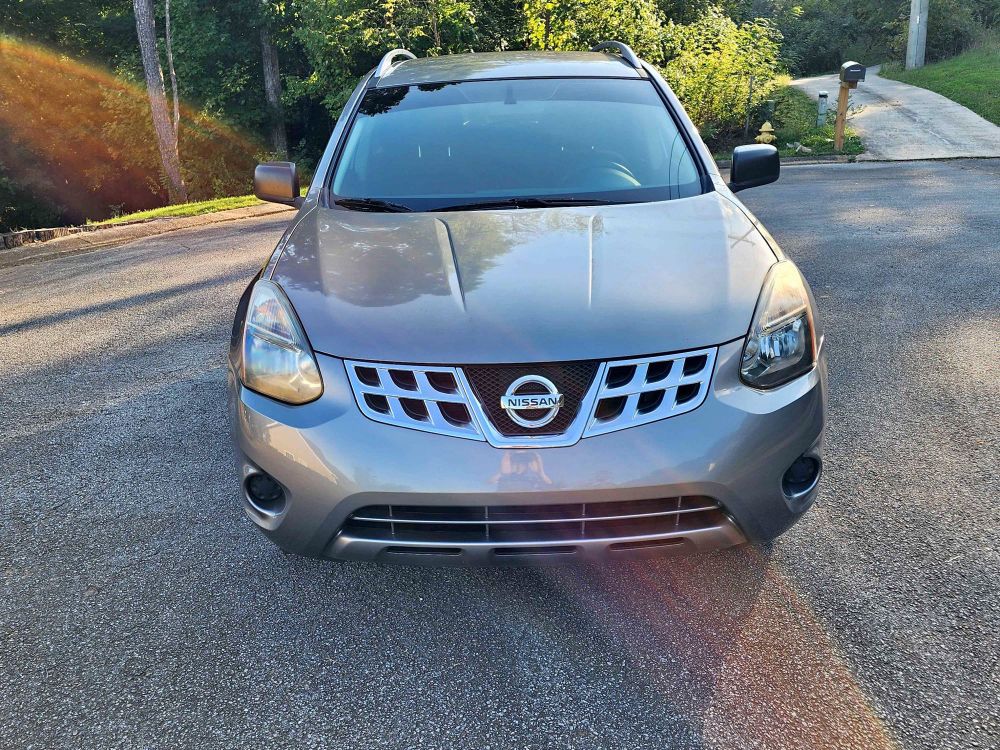 front view of a silver 2015 nissan rogue select. it is a very standard looking automobile. 