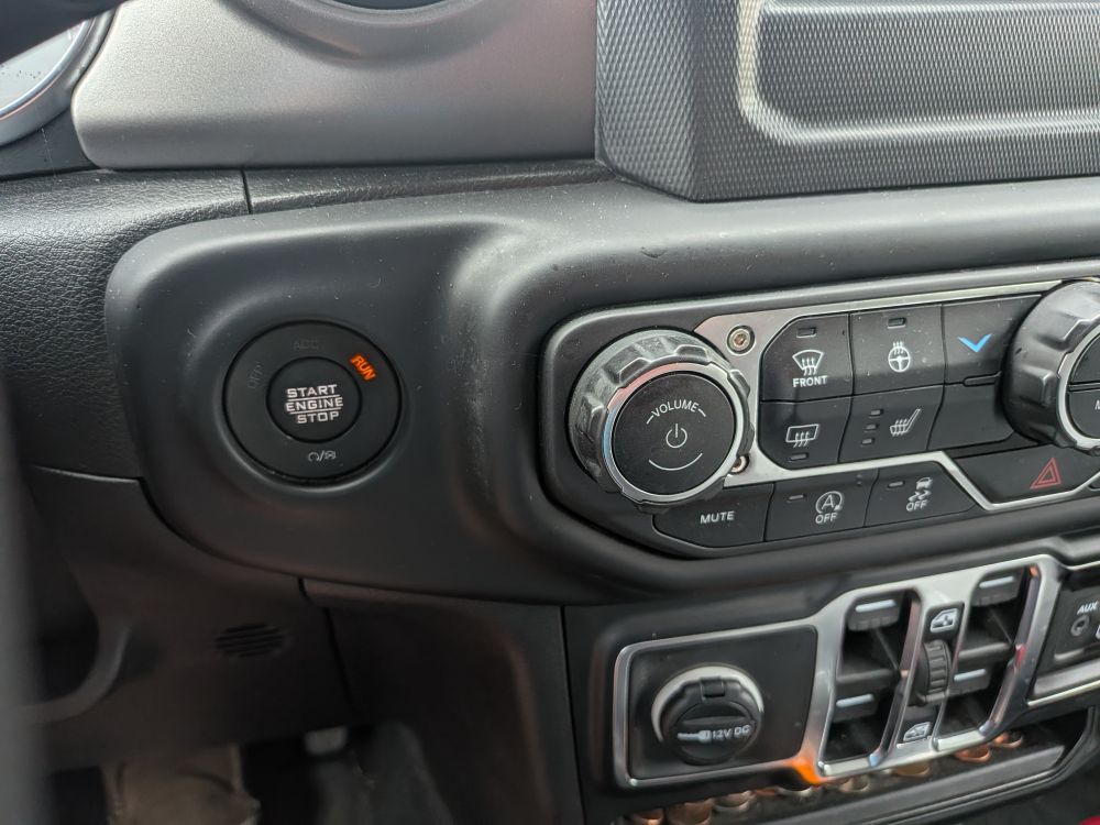 car interior with start button for engine and power button for infotainment in close proximity