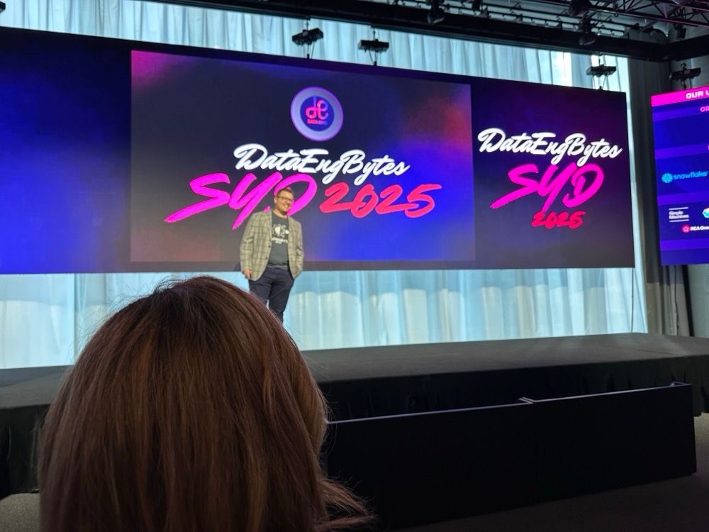 A man onstage at a conference with a slide that reads DataEngBytes Sydney