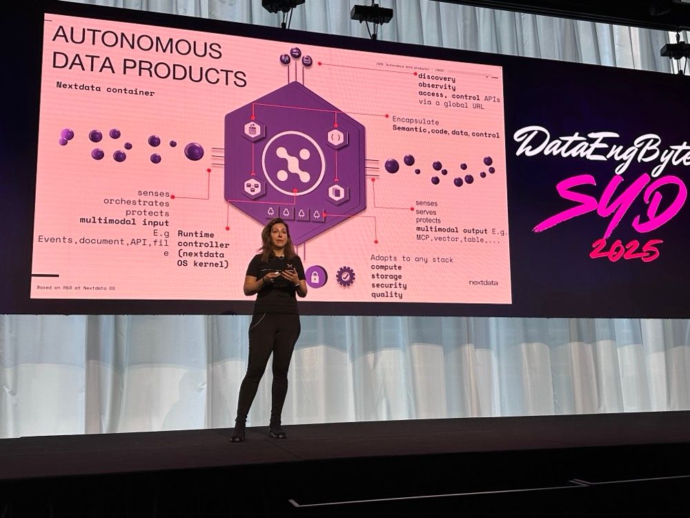 A woman presenting on stage at a tech conference