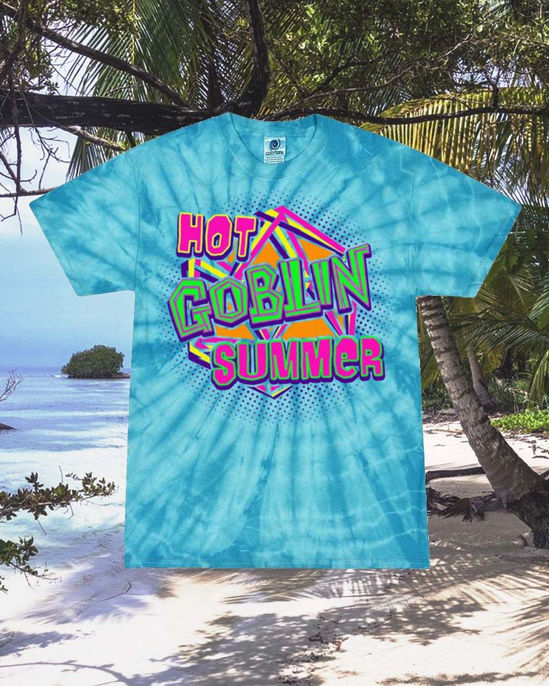 A vibrant blue spiral tie dye printed with a Hot Goblin Summer logo. The foreground text reads Hot Goblin Summer with 'Hot' and 'Summer' in a vibrant pink outlined with yellow and green, and with 'Goblin' in a chunky vibrant green text. The bacground is three linework d20s shattered and overlapping in yellow, pink and purple, with purple halftones spreading out in a circle 