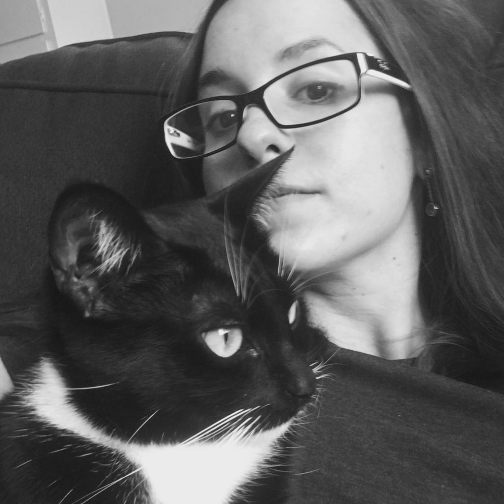A black and white photograph of RK Ashwick and her cat.