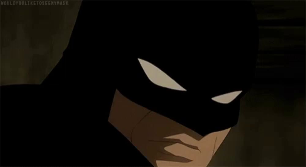 a close up of a silhouette of batman 's face with a white eye .