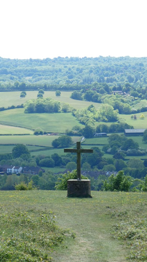 A view of Kent countryside with a wooden cross in the foreground 