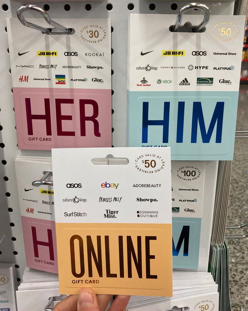 three giftcards that say in large font across the front: Her, Him, and Online