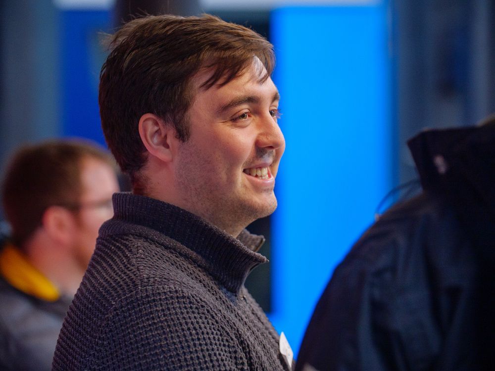 Attendee smiling at the socialising part of the evening