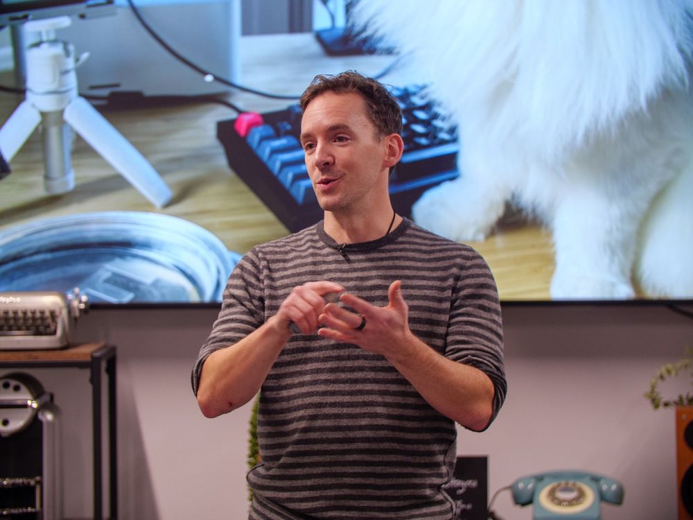 Daniel Roe speaking in front of a picture of his cat