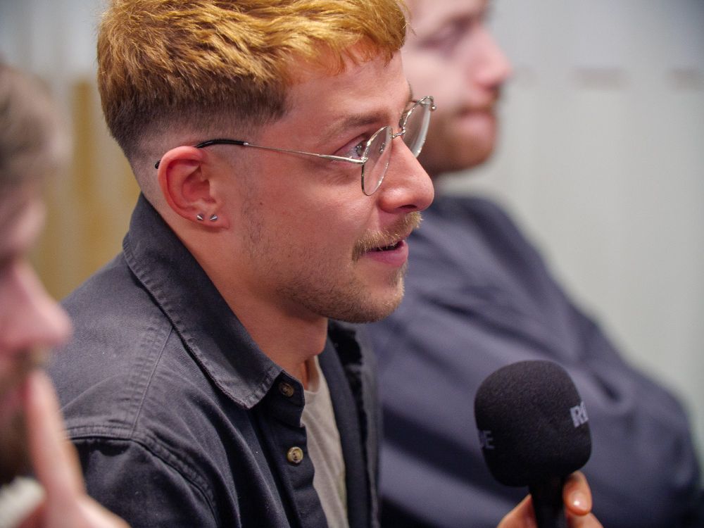 Close up of an audience member asking a question