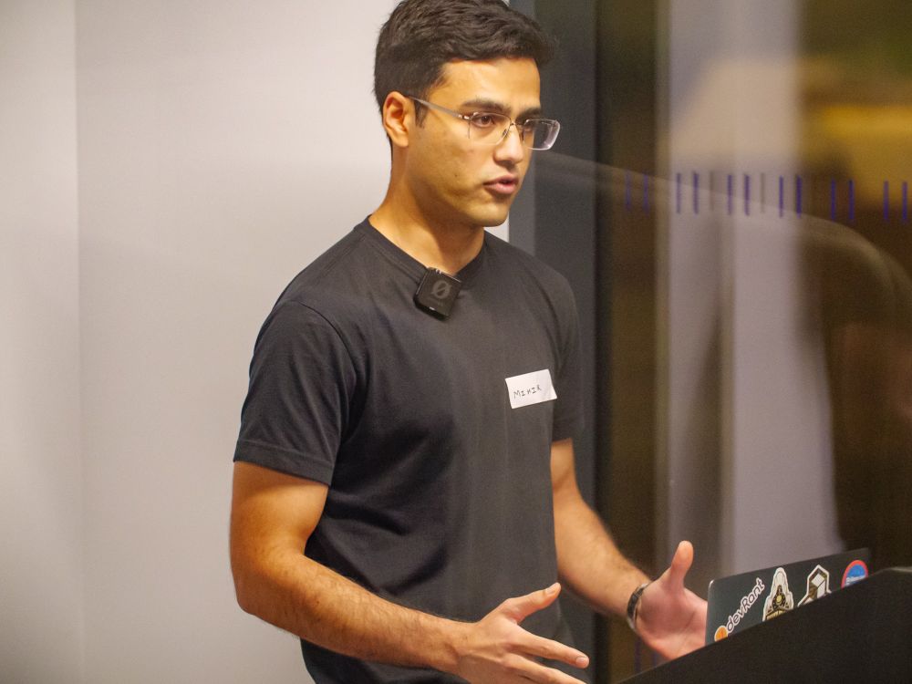 Mihir presenting at the podium