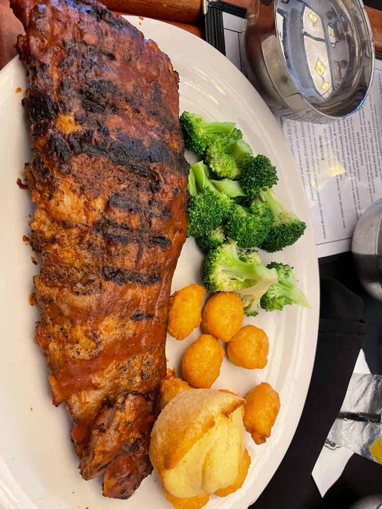 Rack of ribs, cornbread, broccoli, and corn fritters.