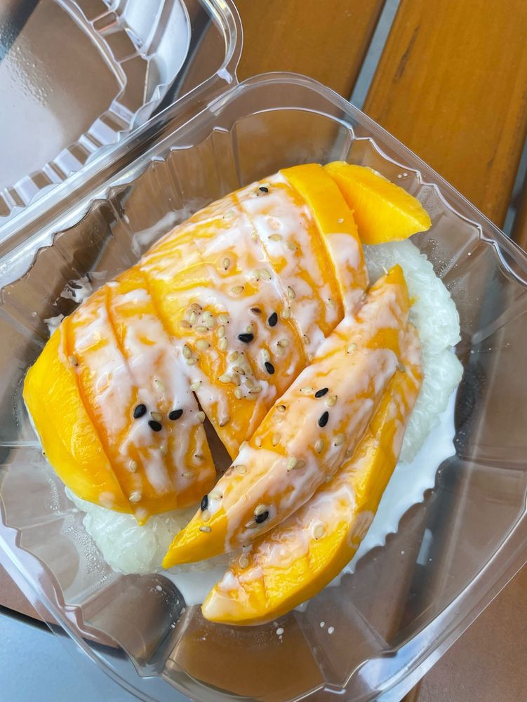 Mango sticky rice with condensed milk and sesame seeds