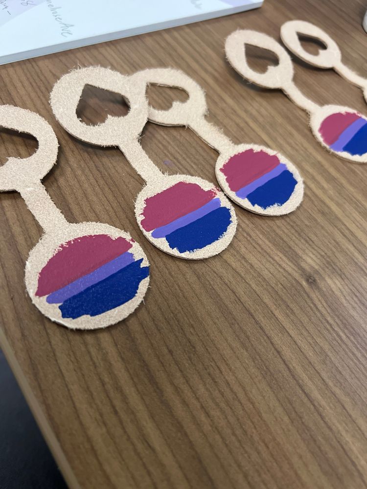 leather heart cutout keychain with a bisexual flag work in progress painting 